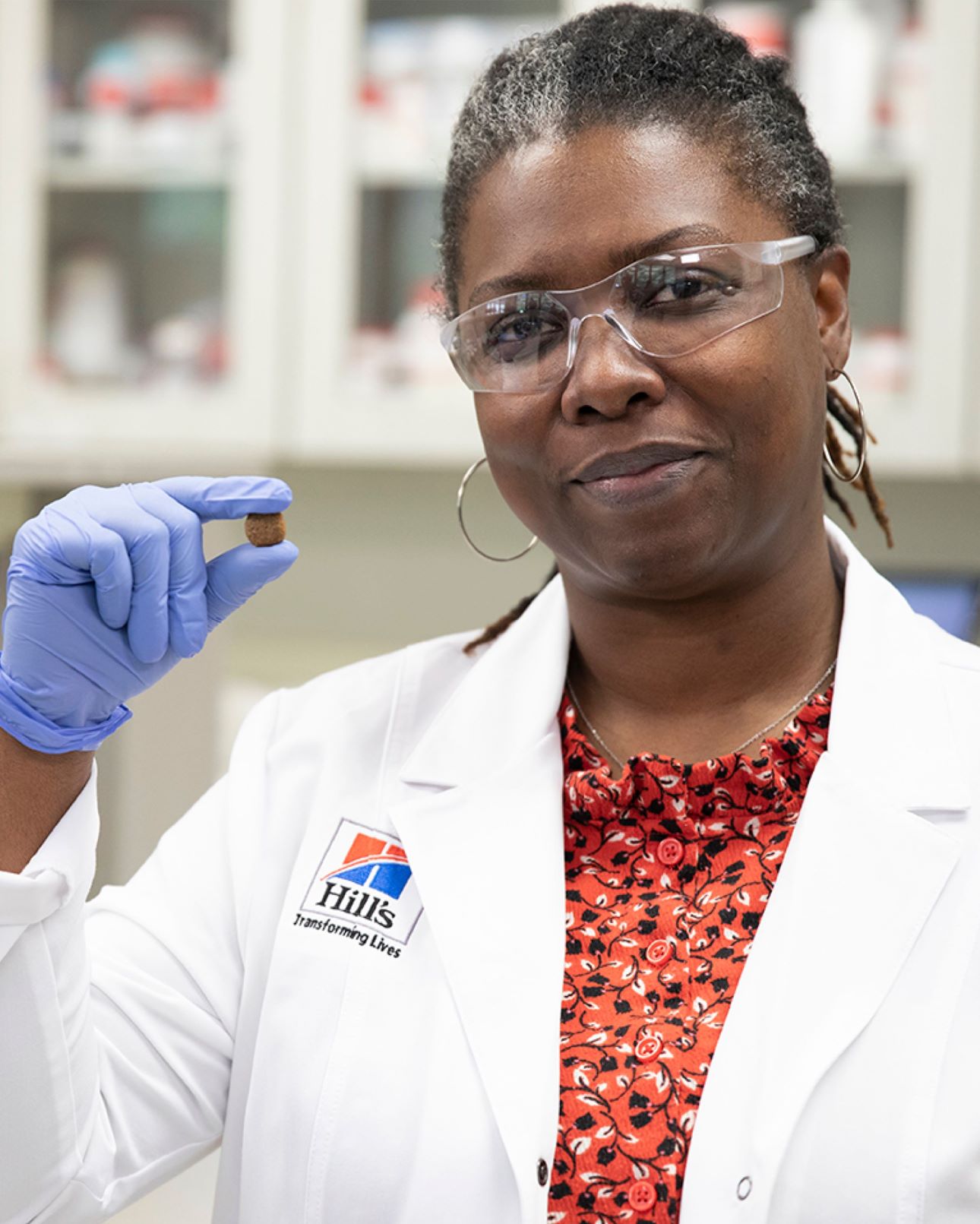 Hill's Pet Nutrition researcher holds Hill's Pet food in her hand