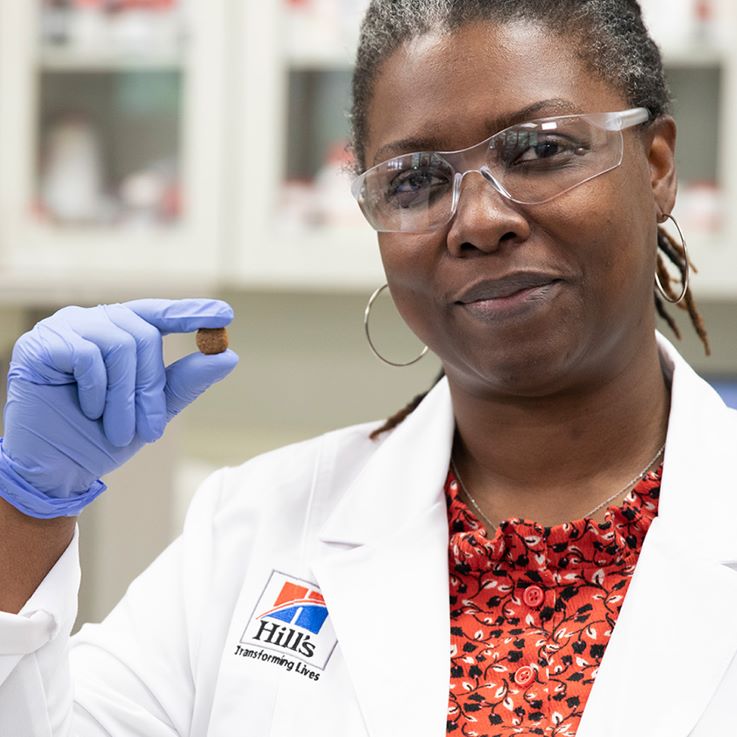 Hill's Pet Nutrition researcher holds Hill's Pet food in her hand