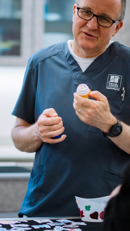 A Hill’s employee playing an educational game with children inside the lab