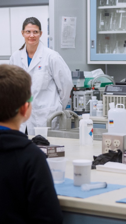 Hill’s Pet Nutrition Centre employees showing lab equipment and materials to children