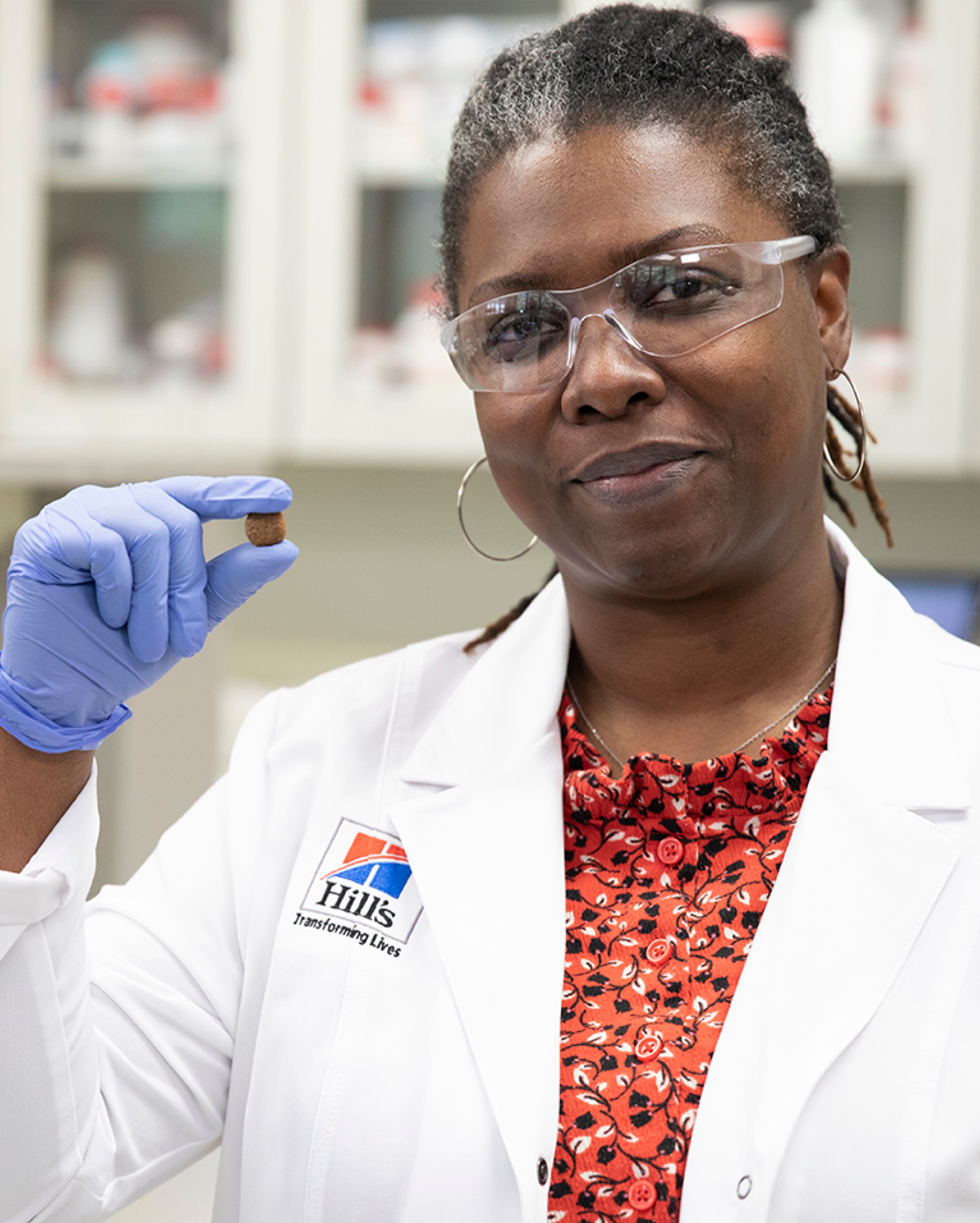 a scientist holding Hill's Pet dog food in her hand